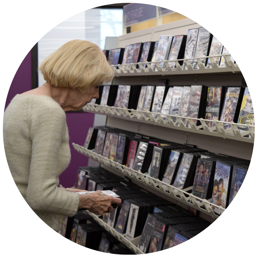 Joyce Cordo shelves DVDs